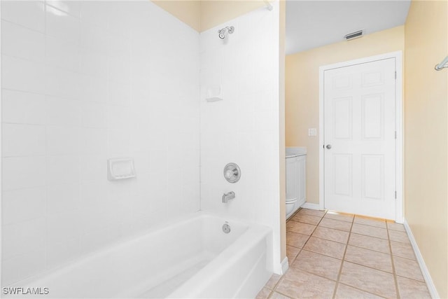 bathroom with tiled shower / bath combo and tile patterned floors