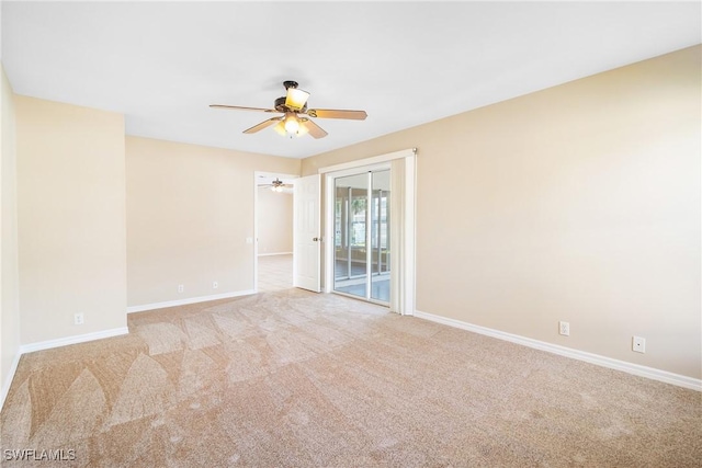 empty room featuring light colored carpet and ceiling fan