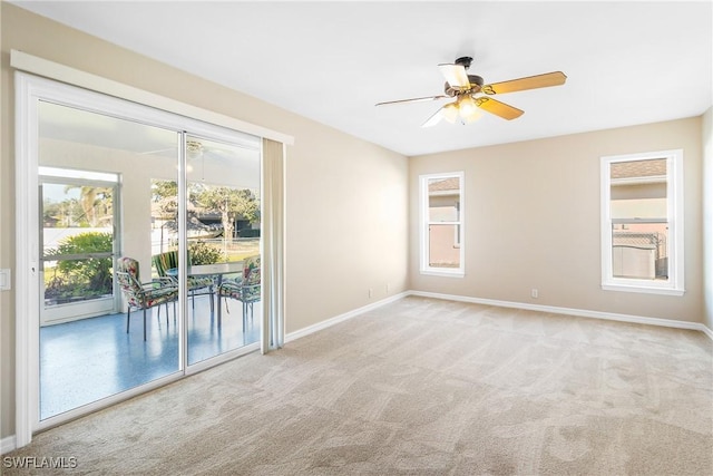 empty room with light colored carpet and ceiling fan