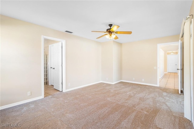 spare room with light carpet and ceiling fan