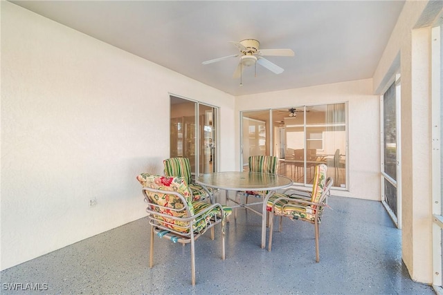 unfurnished sunroom with ceiling fan