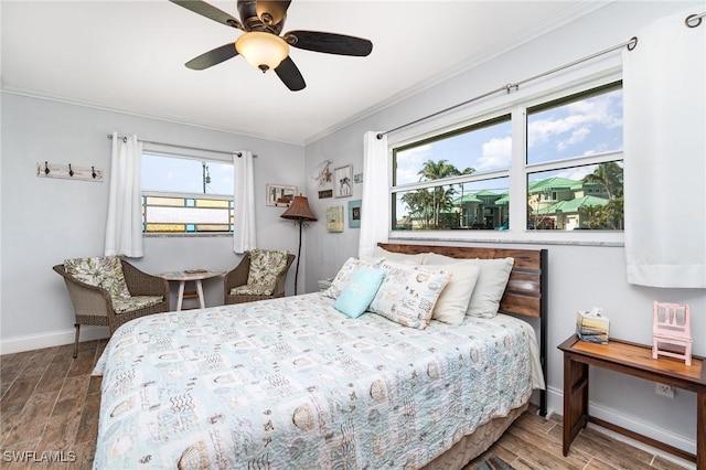 bedroom with crown molding, hardwood / wood-style floors, and ceiling fan