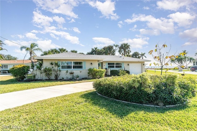 single story home featuring a garage and a front yard