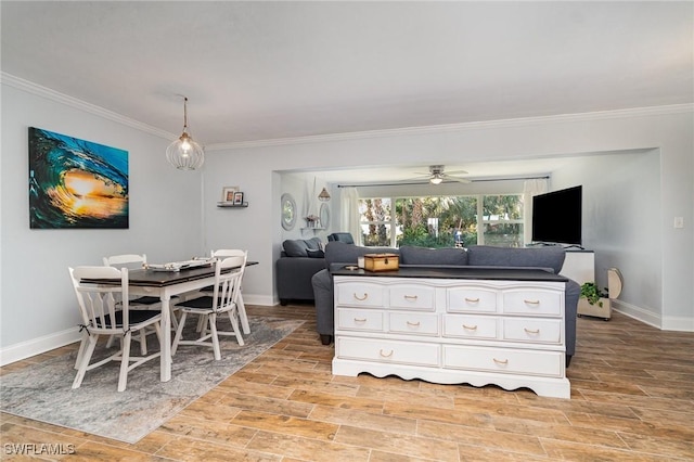 interior space featuring ceiling fan, ornamental molding, decorative light fixtures, and white cabinets