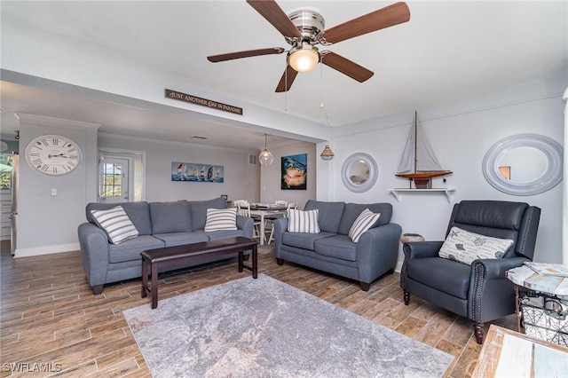 living room featuring crown molding and ceiling fan