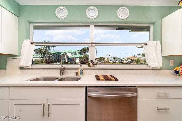 kitchen featuring dishwasher, sink, and white cabinets