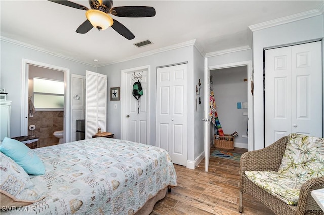 bedroom featuring connected bathroom, ceiling fan, multiple closets, crown molding, and light hardwood / wood-style flooring