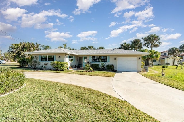 ranch-style house featuring a garage and a front yard