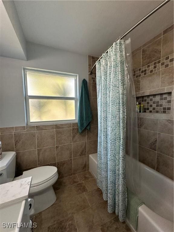 full bathroom with shower / tub combo, vanity, toilet, and tile walls