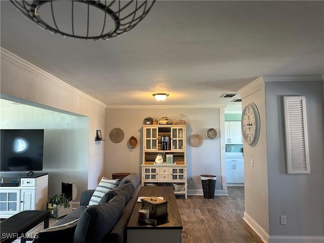 living room with crown molding and dark wood-type flooring