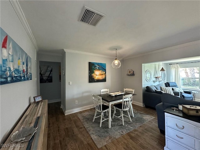 dining room featuring dark wood-type flooring and ornamental molding