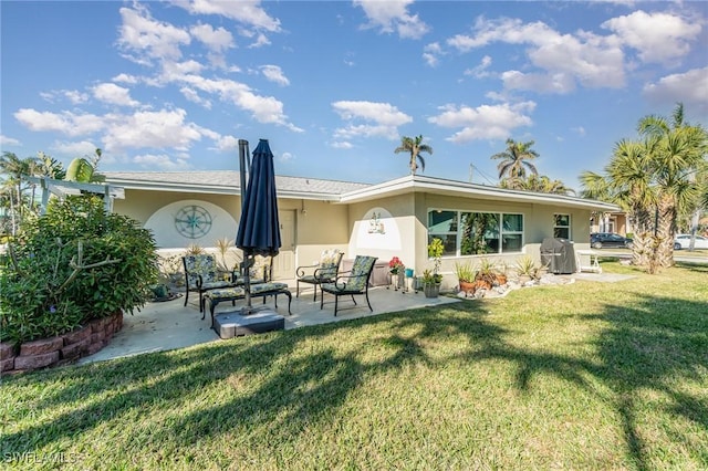 back of house with a patio and a lawn