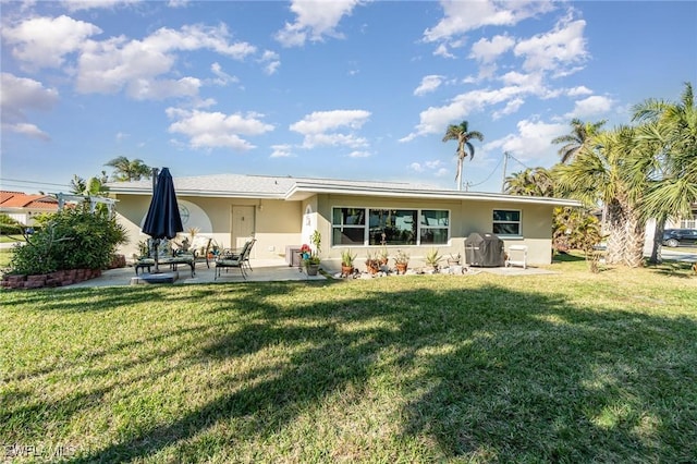 back of house featuring a yard and a patio area