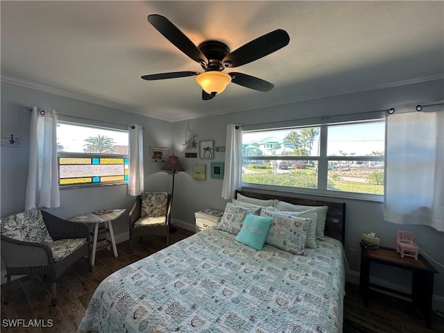 bedroom with ceiling fan, ornamental molding, dark hardwood / wood-style floors, and multiple windows