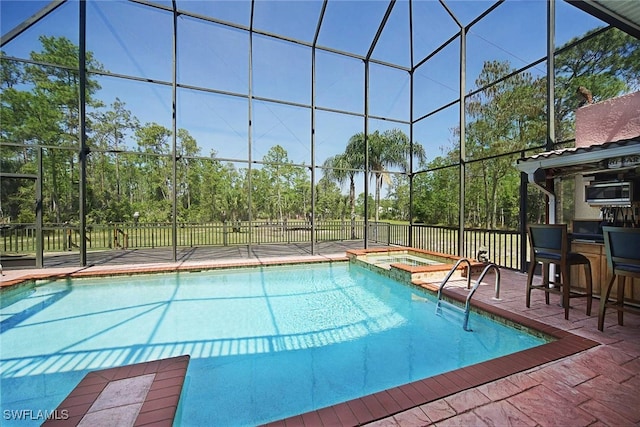 view of swimming pool with an in ground hot tub and a patio