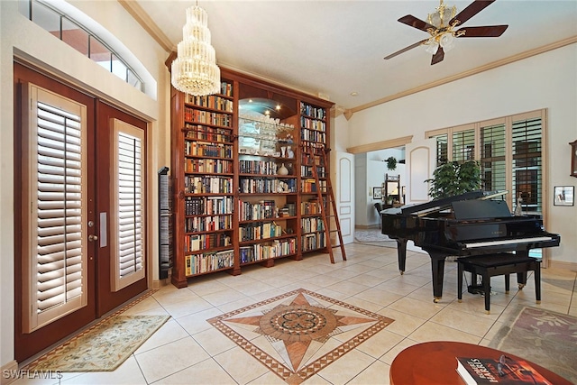 interior space with light tile patterned flooring, ceiling fan with notable chandelier, crown molding, and french doors