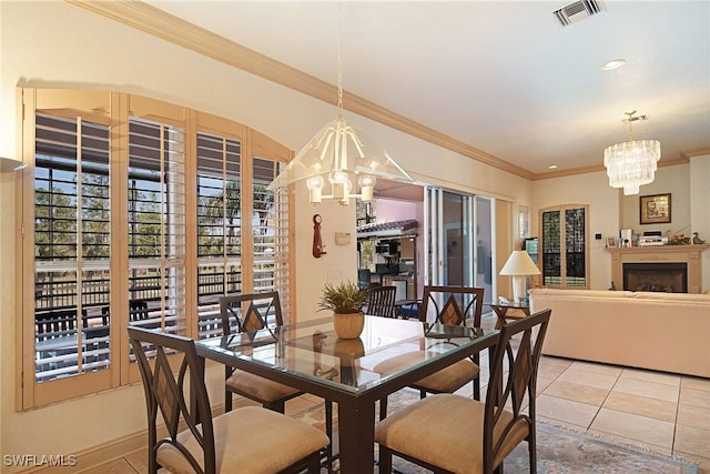 tiled dining space with an inviting chandelier and ornamental molding