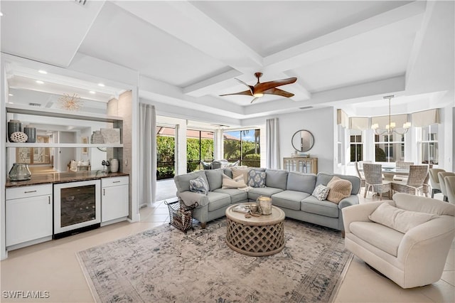 tiled living room with ceiling fan with notable chandelier, beamed ceiling, beverage cooler, coffered ceiling, and bar area