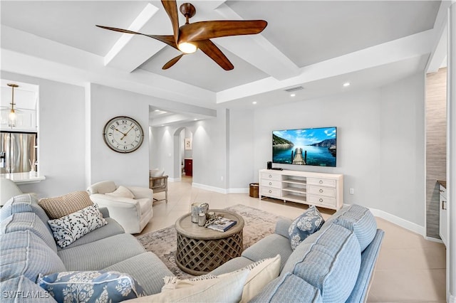 living room featuring beamed ceiling, light tile patterned flooring, and ceiling fan