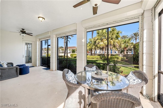 sunroom featuring ceiling fan