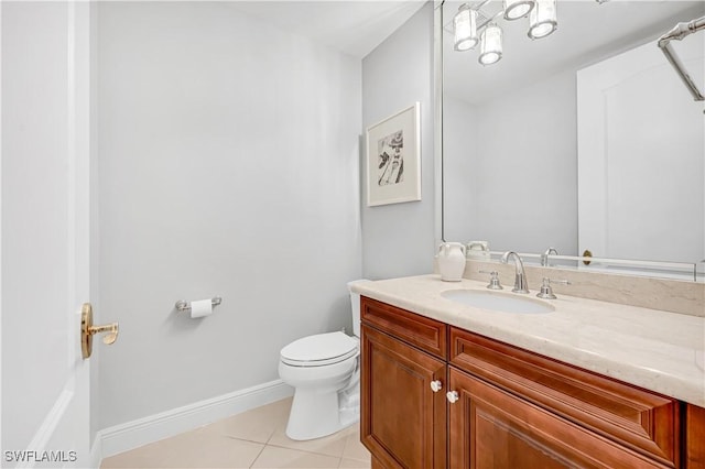 bathroom featuring tile patterned flooring, vanity, and toilet