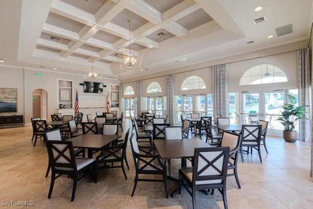 dining area featuring french doors, coffered ceiling, a notable chandelier, a towering ceiling, and beam ceiling