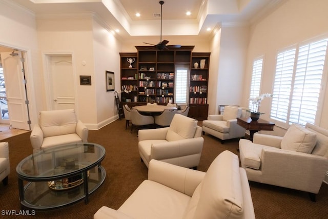 carpeted living room featuring a towering ceiling and ornamental molding