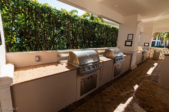 view of patio with an outdoor kitchen and grilling area