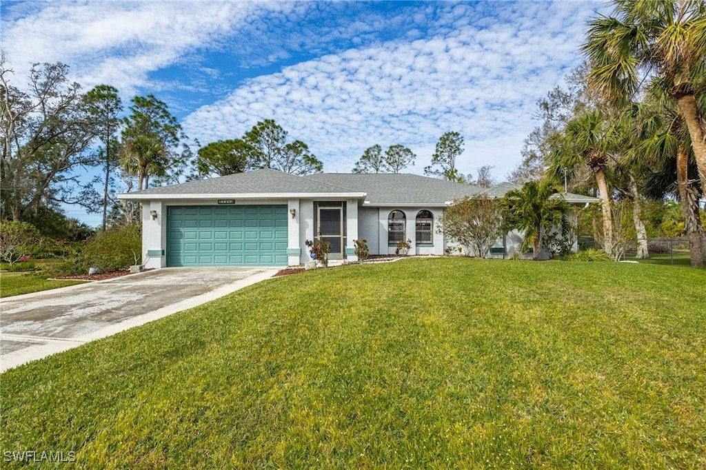 ranch-style home with a garage and a front lawn