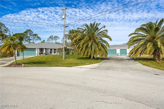 view of front of house with a garage and a front yard