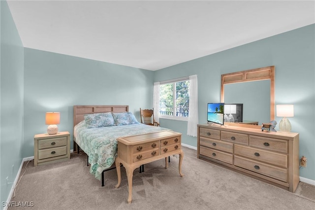 bedroom featuring light carpet