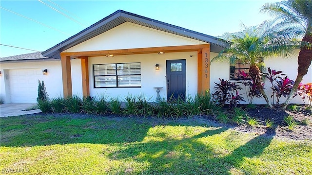 view of front of home featuring a garage and a front lawn