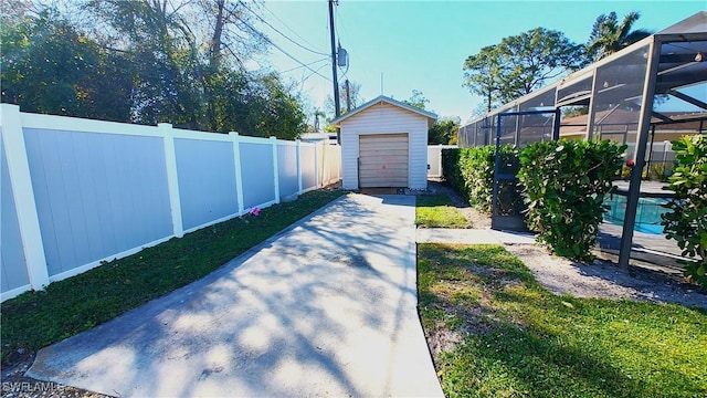 view of yard with a storage shed and glass enclosure