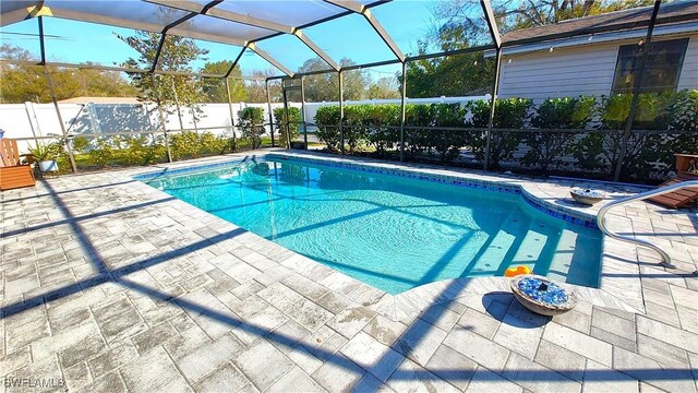 view of pool with a lanai and a patio area