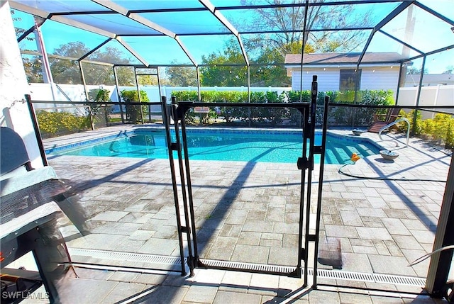 view of pool with a lanai and a patio