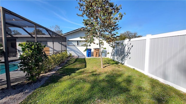 view of yard featuring a fenced in pool and glass enclosure