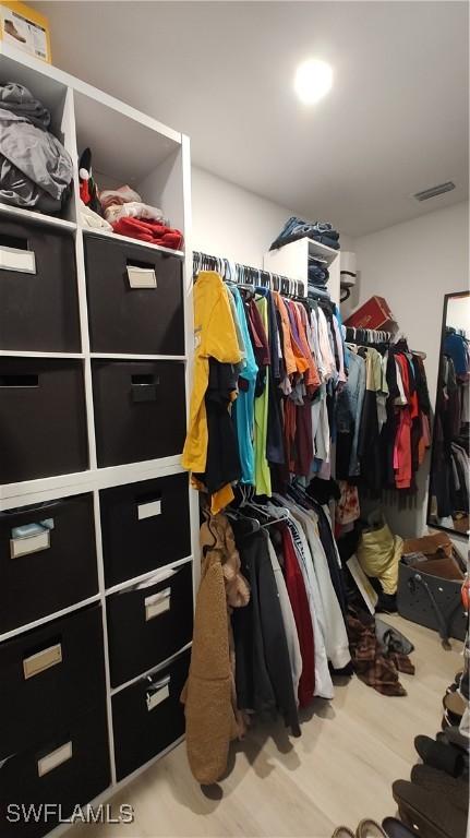 spacious closet with visible vents and wood finished floors