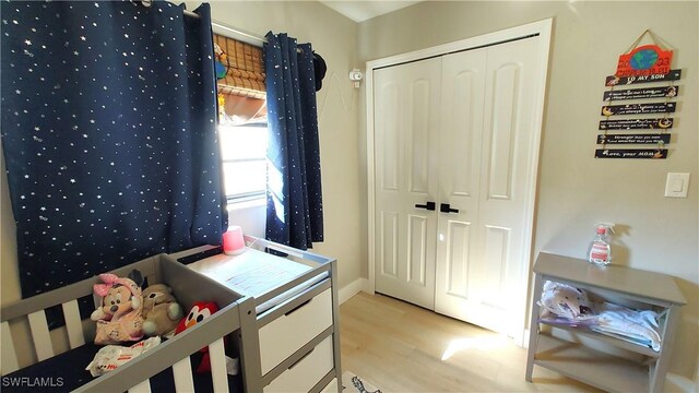 bedroom featuring a closet and light wood-type flooring