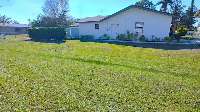 exterior space with fence and a yard