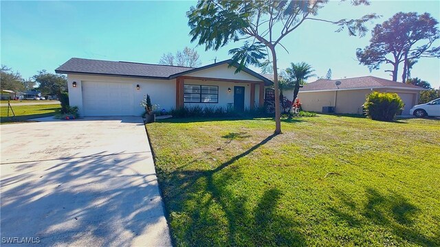 single story home with central AC unit, an attached garage, driveway, stucco siding, and a front yard