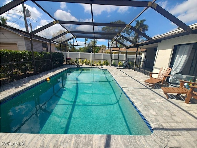 view of pool with a patio and a lanai