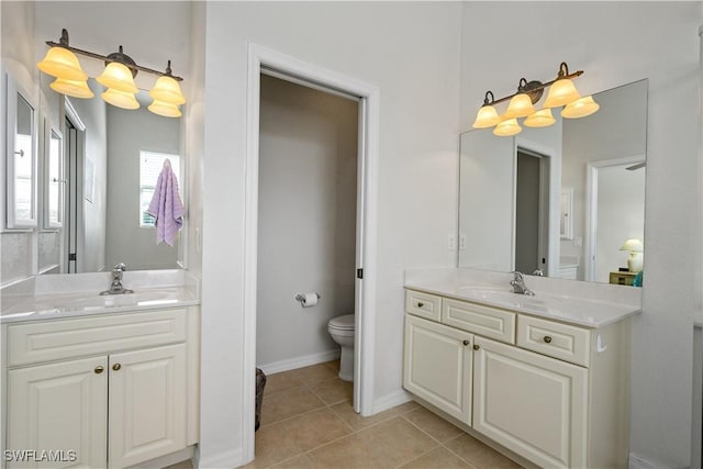 bathroom featuring vanity, tile patterned floors, and toilet