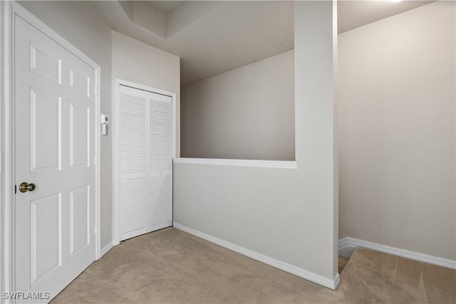 interior space with light colored carpet and a closet