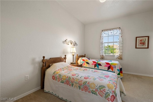 carpeted bedroom featuring vaulted ceiling