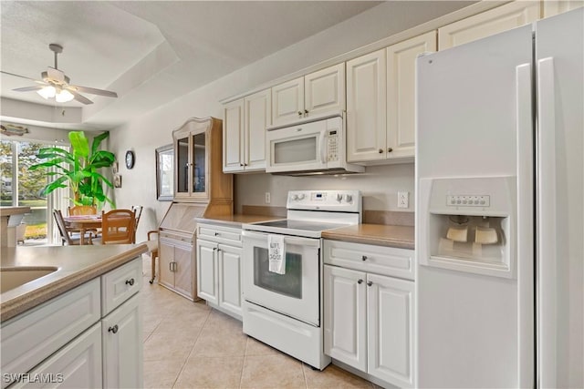 kitchen featuring ceiling fan, light tile patterned floors, white cabinets, and white appliances