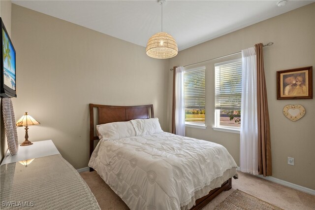 carpeted bedroom with baseboards