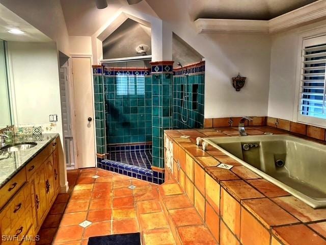 bathroom with vaulted ceiling, vanity, shower with separate bathtub, and tile patterned flooring