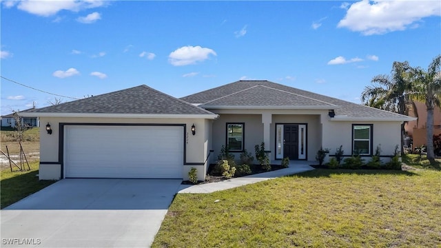 view of front of property featuring a garage and a front lawn