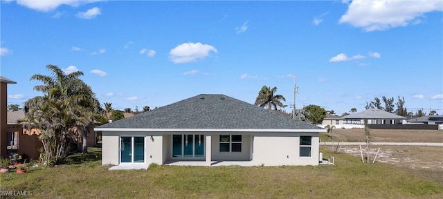 rear view of house featuring a yard