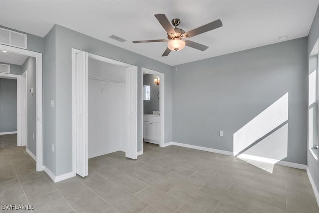 unfurnished bedroom with a closet, ceiling fan, and ensuite bathroom